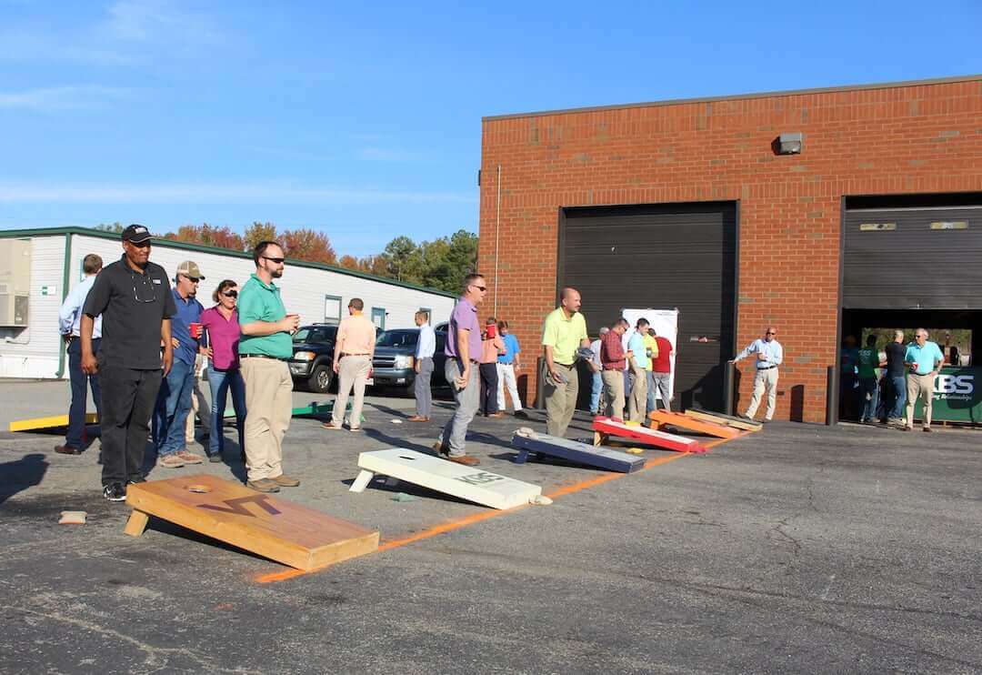 Six different groups playing cornhole for a tournament at the KBS "Bags Stew and Brew" event.